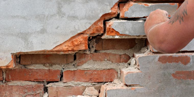 repointing damaged brick wall